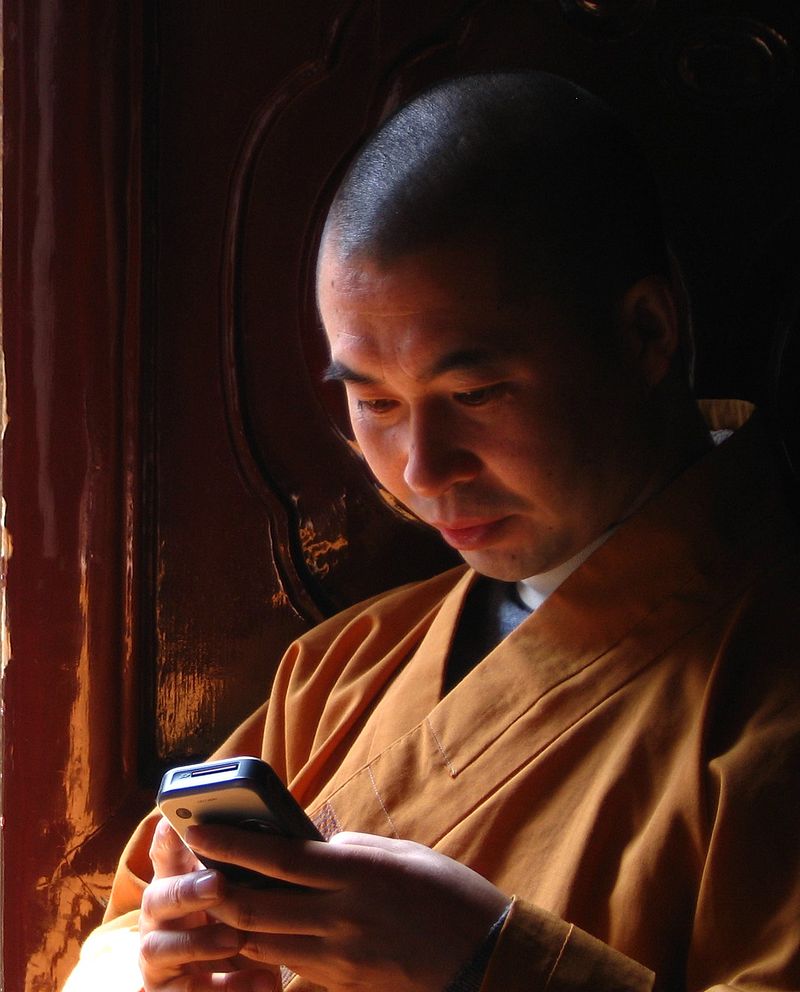 buddhist monk on phone